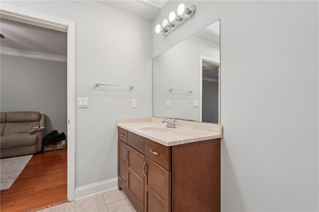 1330 Primrose Park Road Sugar Hill, GA 30518 - Photo 48 of 76 a bathroom with a sink a mirror and a vanity
