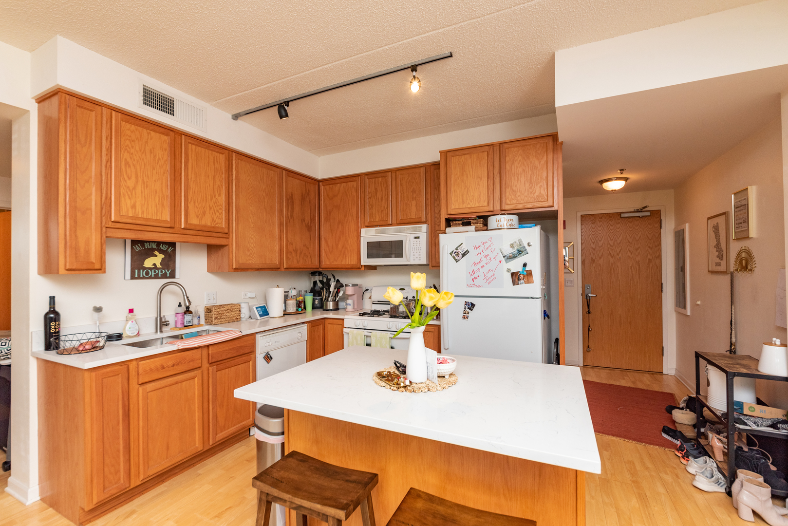 1250 South Indiana Avenue, Unit 812 Chicago, IL 60605 - Photo 4 of 23 a kitchen with a sink a stove a refrigerator cabinets and dining table