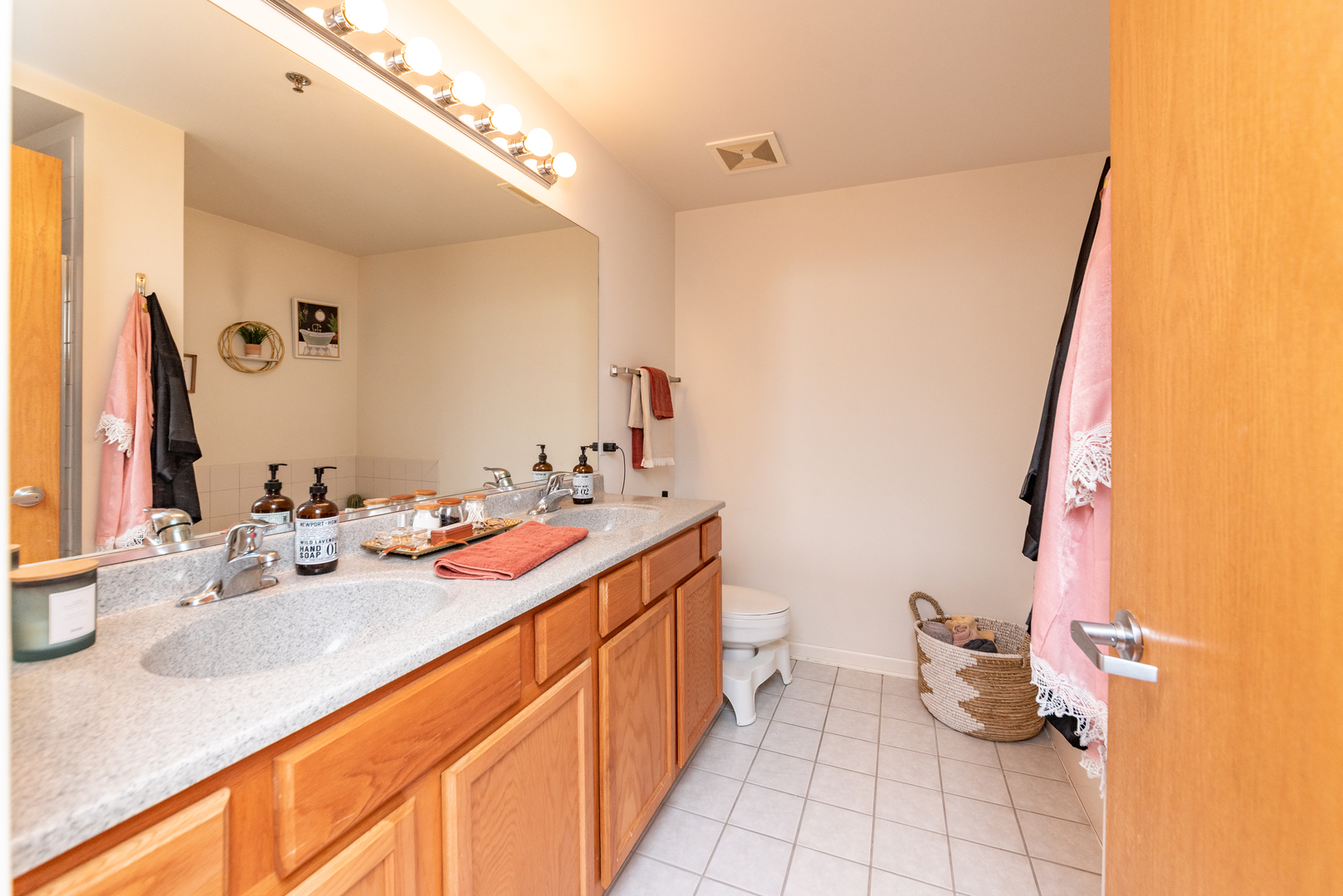 1250 South Indiana Avenue, Unit 812 Chicago, IL 60605 - Photo 9 of 23 a bathroom with a double vanity sink and a mirror