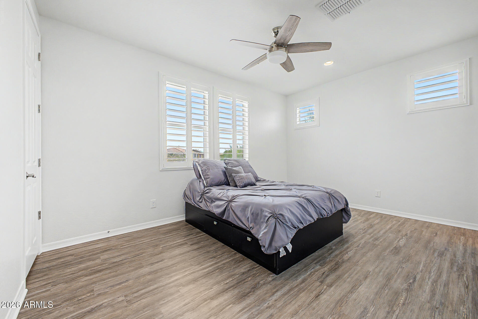 1076 East Kensington Road Gilbert, AZ 85297 - Photo 18 of 73 a spacious bedroom with a bed and a ceiling fan