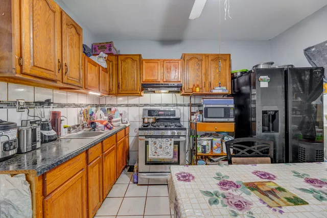 a kitchen with stainless steel appliances wooden cabinets and a stove top oven