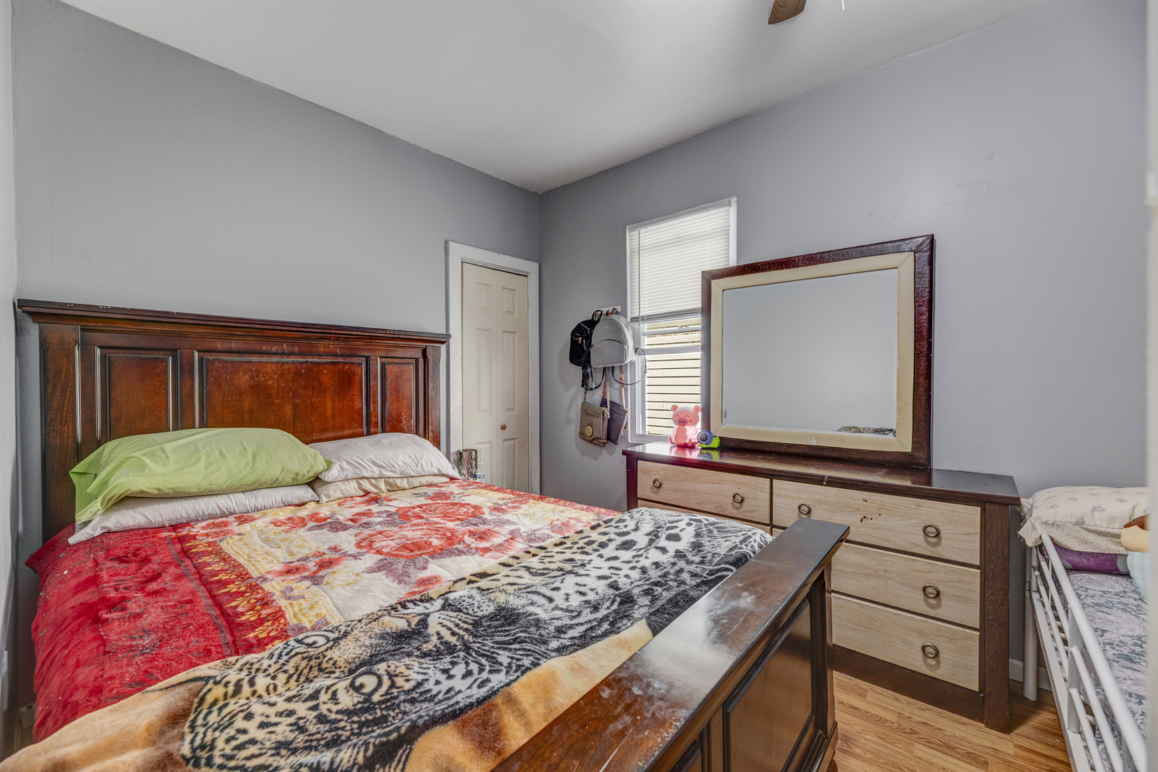 2208 West 54th Place Chicago, IL 60609 - Photo 9 of 18 a bedroom with a bed and a dresser