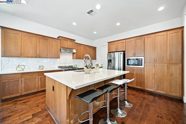 a kitchen with counter top space sink stove and refrigerator