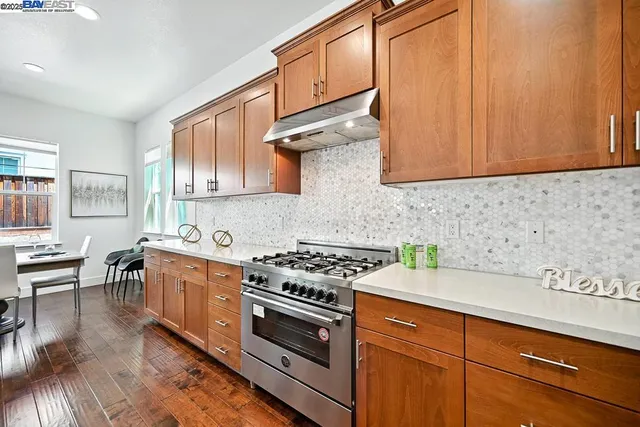 a kitchen with stainless steel appliances granite countertop a stove and a refrigerator