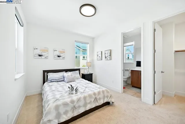 a bedroom with a large bed a couch and a window