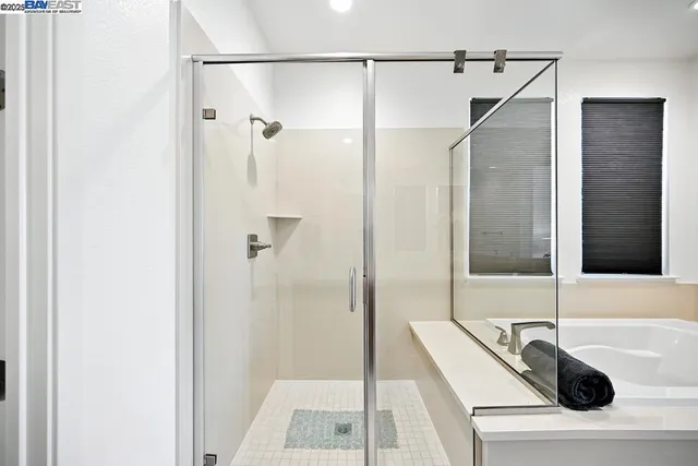 a bathroom with a sink a toilet a large mirror and shower