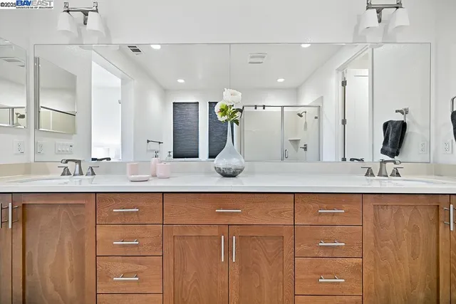 a patio with table and chairs and potted plants