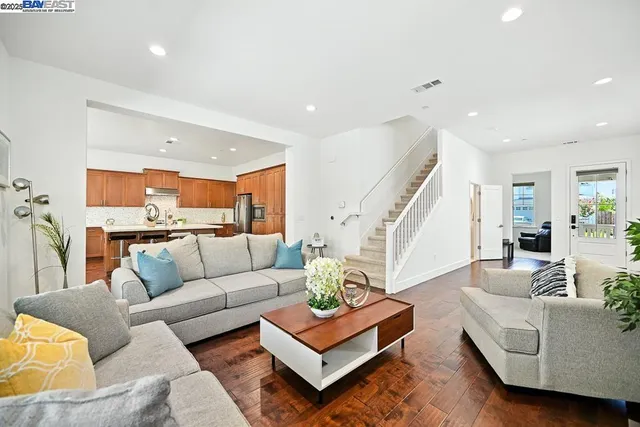 a kitchen with a dining table chairs and white appliances