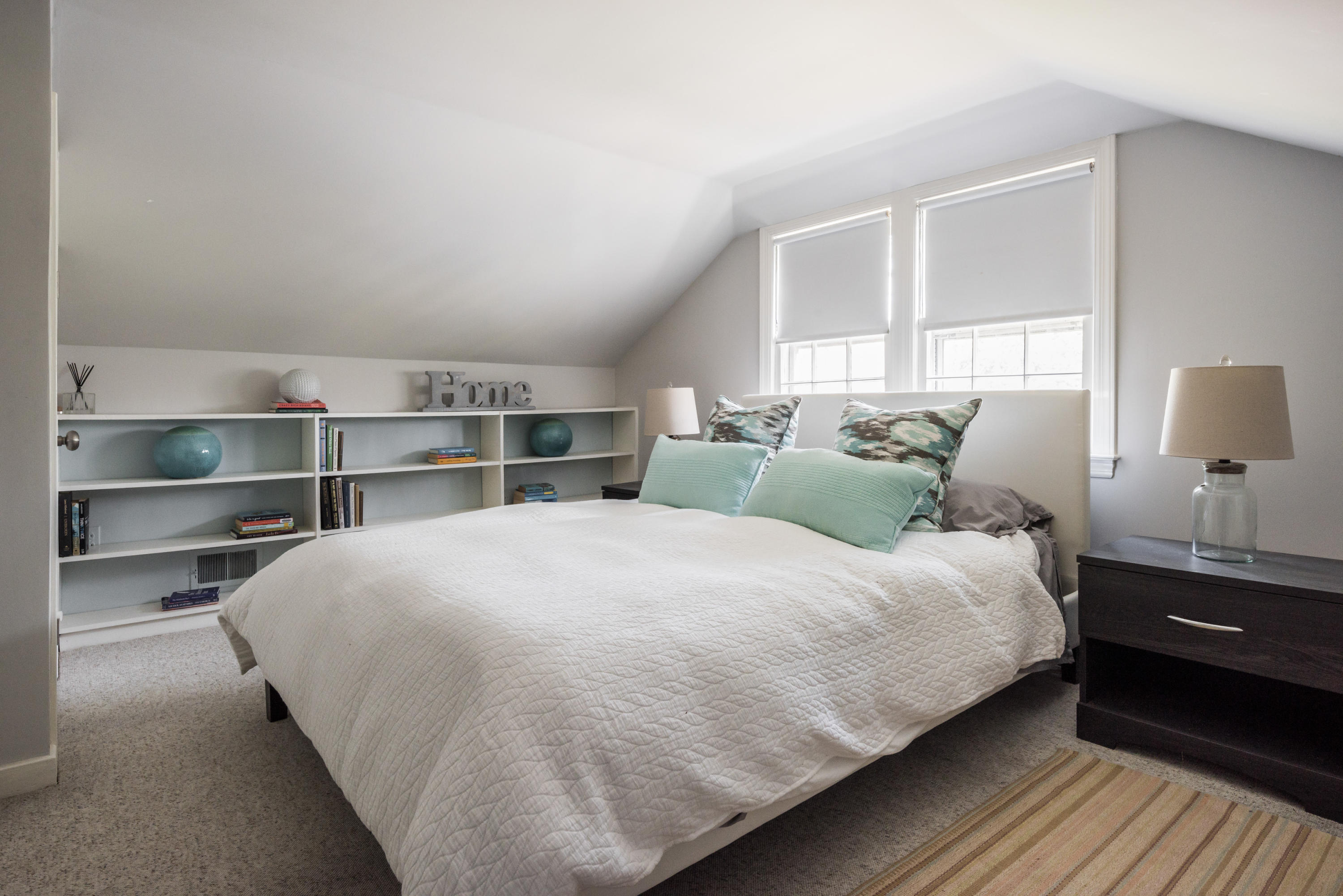 3 Haskell Lane Darien, CT 06820 - Photo 13 of 21 a large bed sitting in a bedroom next to a window with lamp