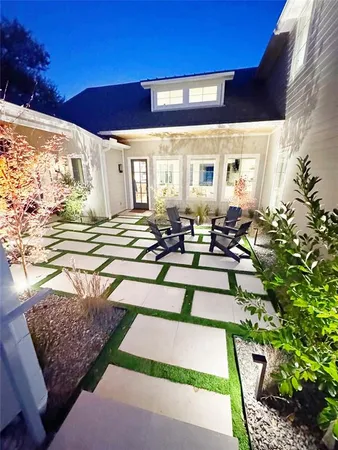 a view of a patio with table and chairs potted plants with wooden floor