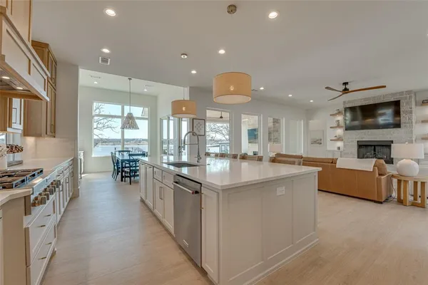 a kitchen with stainless steel appliances granite countertop a stove and cabinets