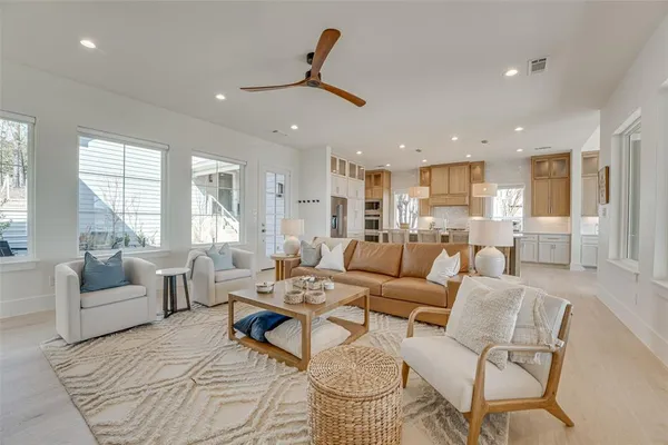 a living room with furniture and kitchen view