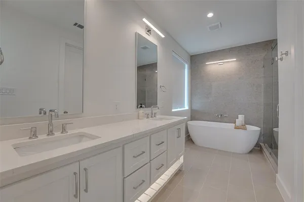 a bathroom with a double vanity sink mirror and double
