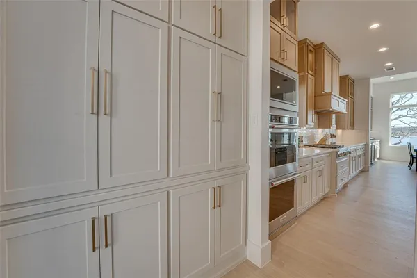 a kitchen with white cabinets and white appliances