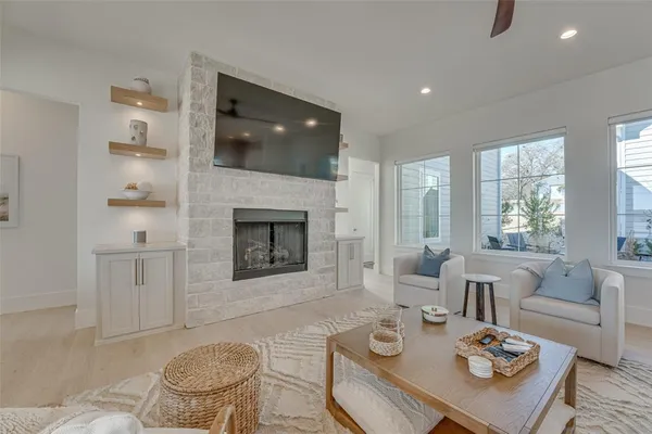 a living room with furniture a flat screen tv and a fireplace