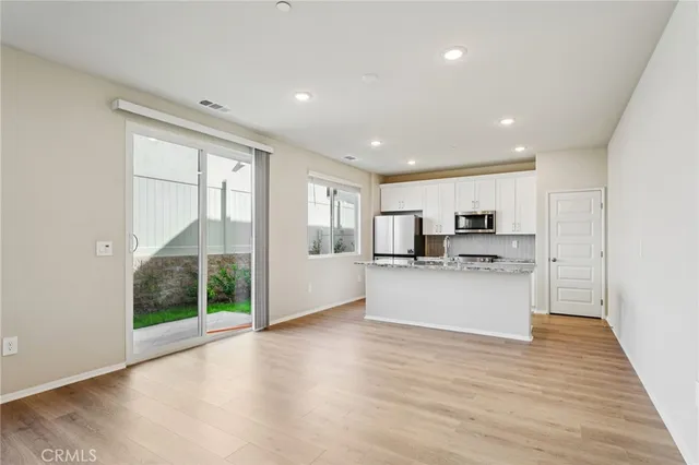 a view of kitchen with stainless steel appliances refrigerator oven and microwave