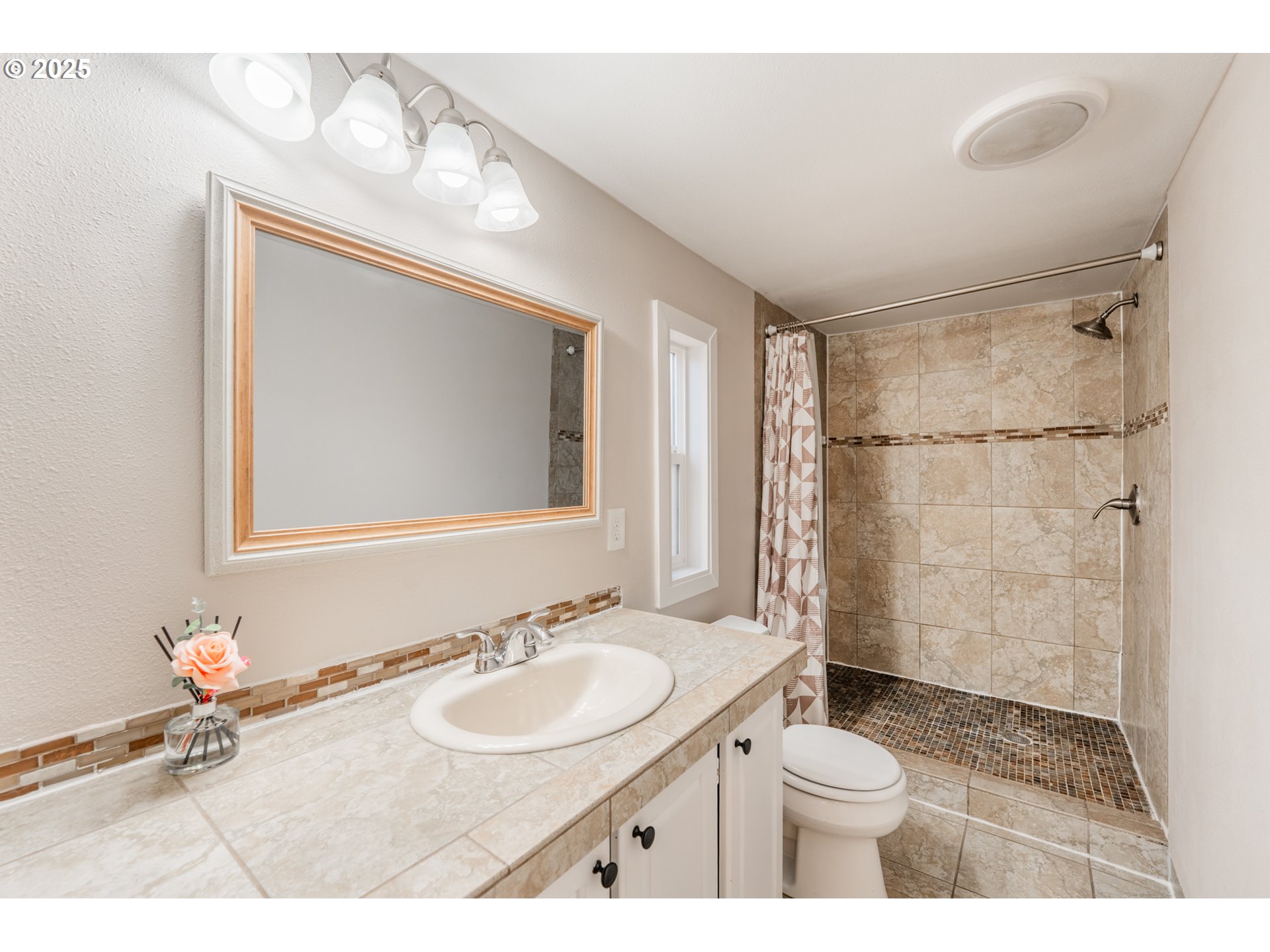 428 Southwest Boston Way, Unit 73 Beaverton, OR 97006 - Photo 16 of 25 a bathroom with a sink toilet a mirror and shower