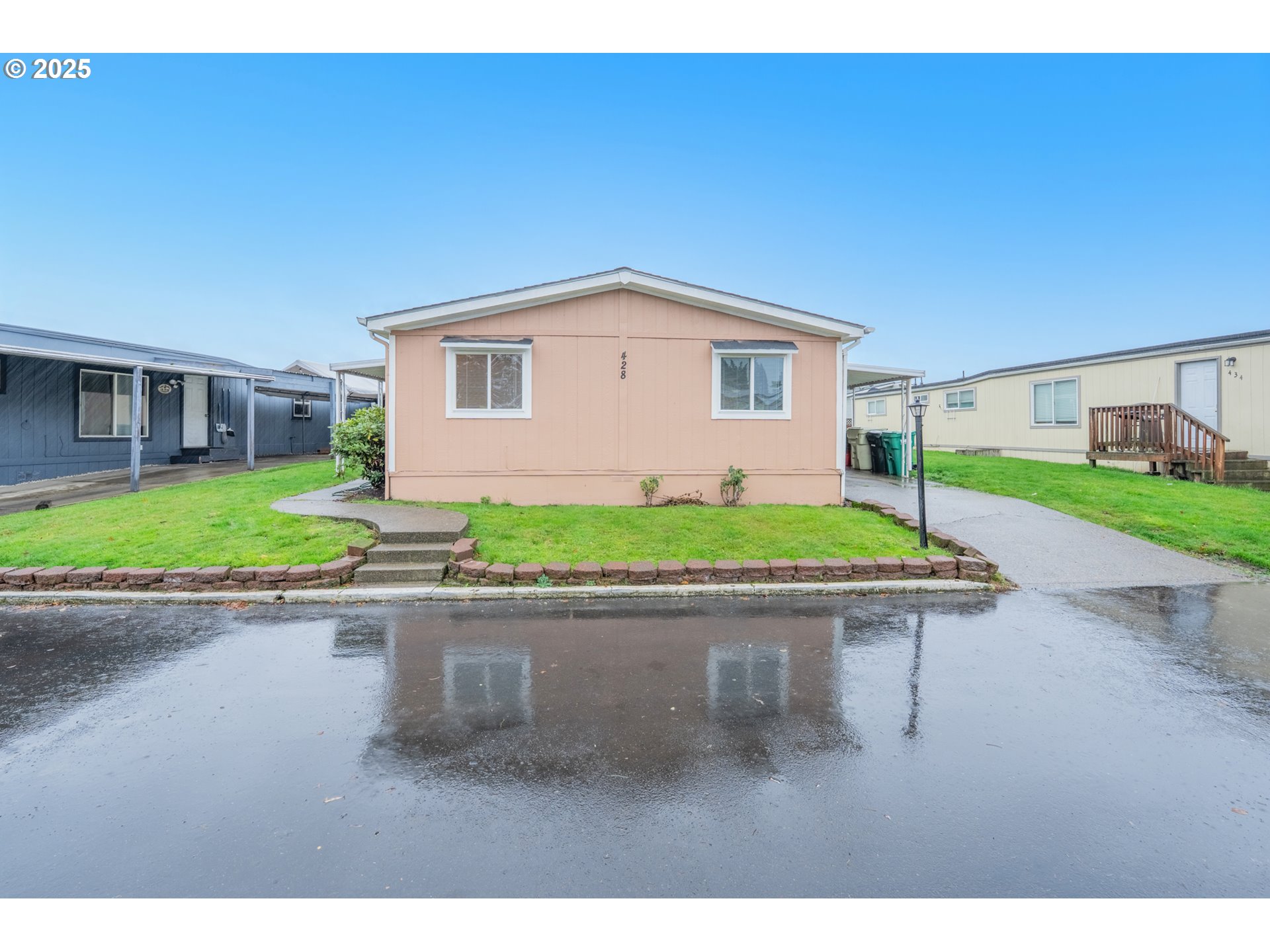 428 Southwest Boston Way, Unit 73 Beaverton, OR 97006 - Photo 25 of 25 a small house with a bench in front of it