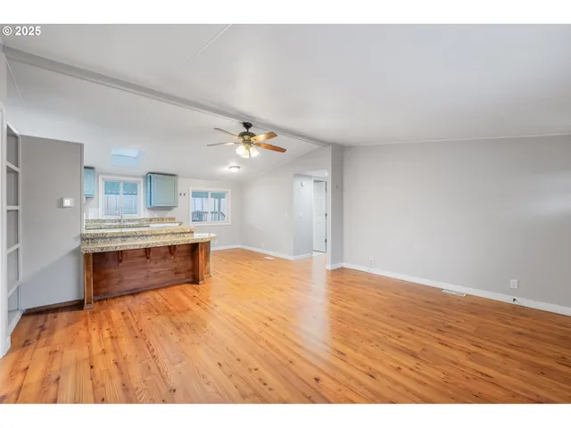 a view of kitchen with kitchen island microwave and stove