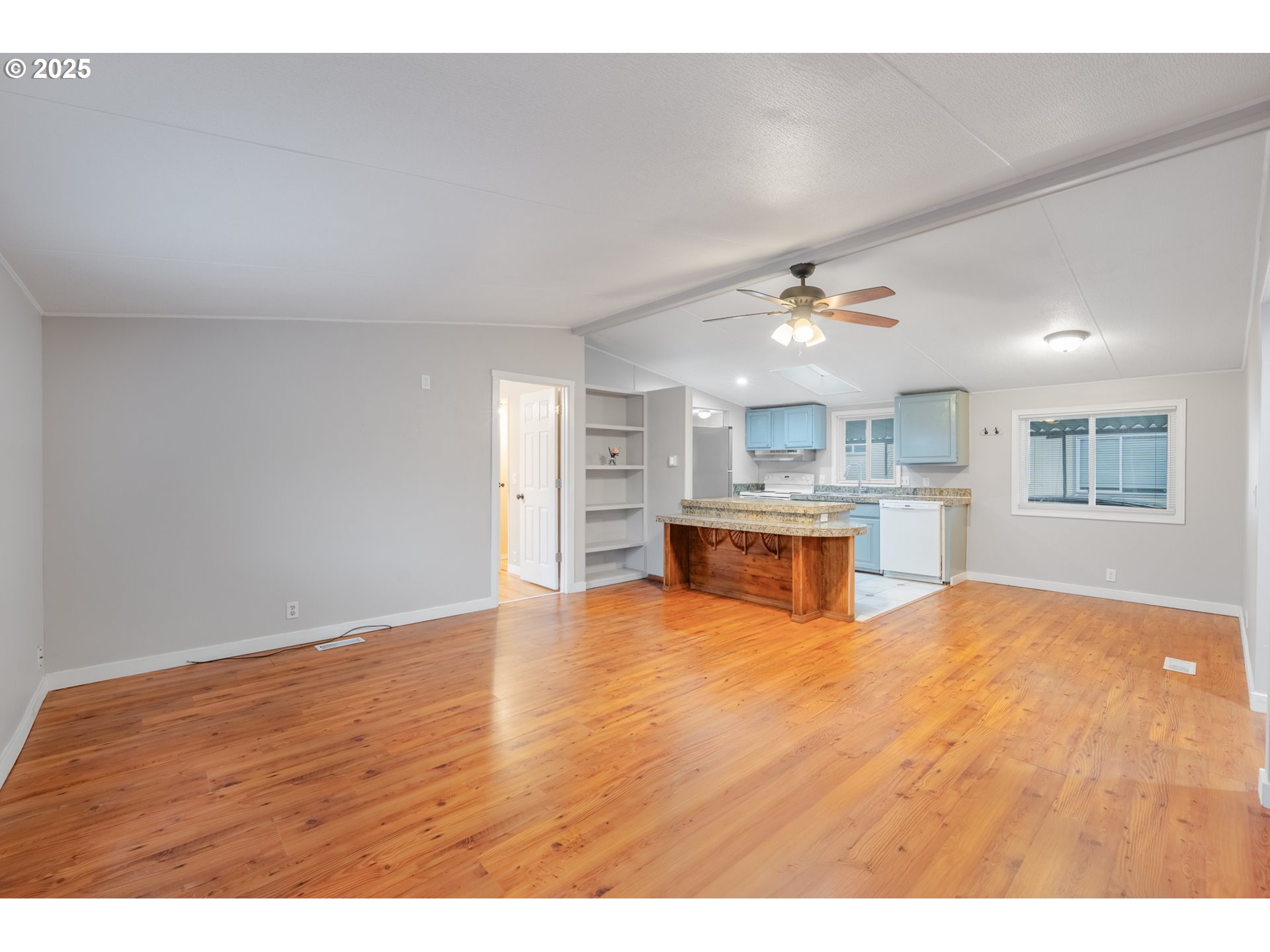 428 Southwest Boston Way, Unit 73 Beaverton, OR 97006 - Photo 6 of 25 a view of an empty room with a kitchen
