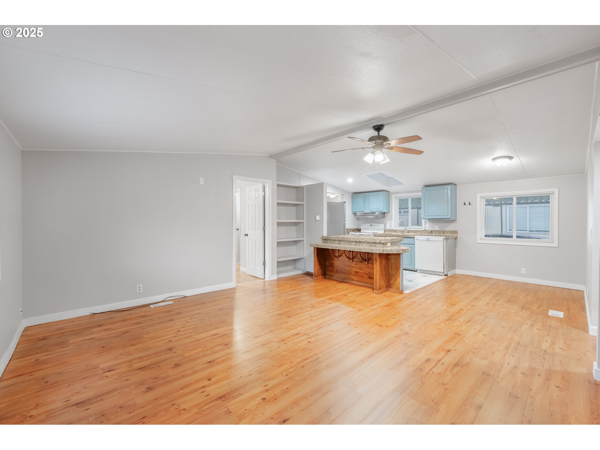 428 Southwest Boston Way, Unit 73 Beaverton, OR 97006 - Photo 7 of 25 a view of an empty room with a kitchen