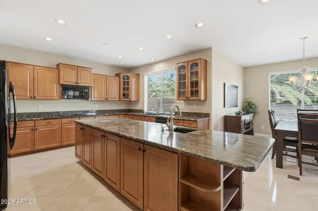 a kitchen with sink stove and refrigerator