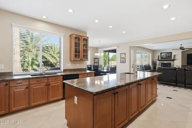 a kitchen with stainless steel appliances granite countertop a stove refrigerator and a sink