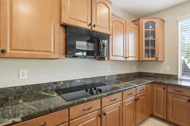 a view of a dining room with furniture a chandelier and wooden floor