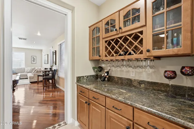 a living room with furniture floor to ceiling window and wooden floor