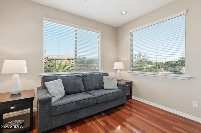 a bedroom with a bed and a lamp on dresser