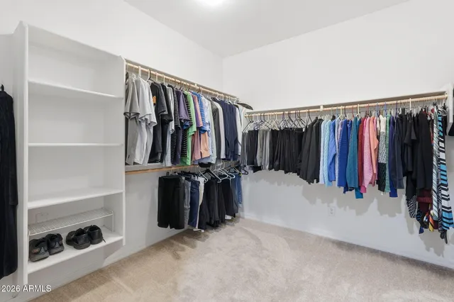a bedroom with a large bed and a ceiling fan
