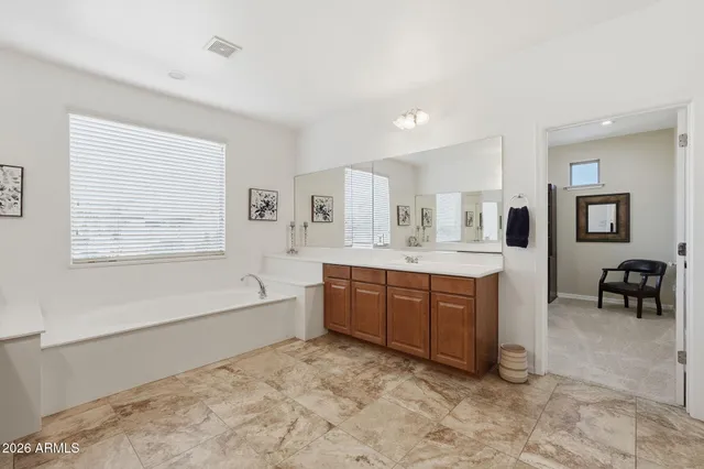 a bathroom with a granite countertop sink a toilet and a large mirror