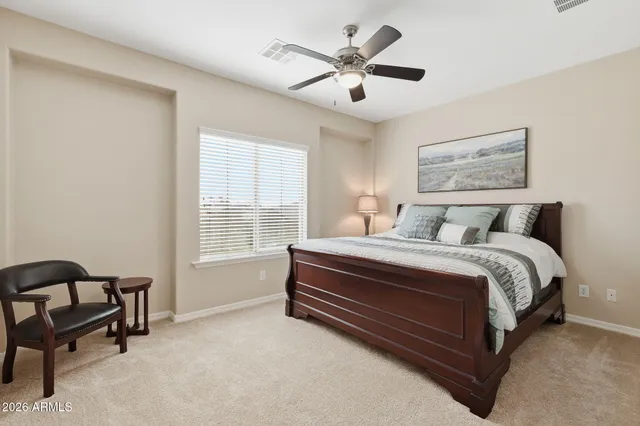 a palm tree sitting in front of a house with a big yard