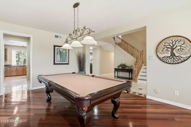 a large kitchen with granite countertop lots of counter space sink and cabinets