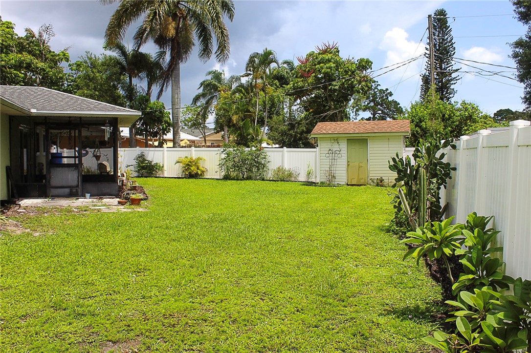 102 Cardinal Drive Sebastian, FL 32958 - Photo 13 of 34 a view of a house with a backyard and a patio