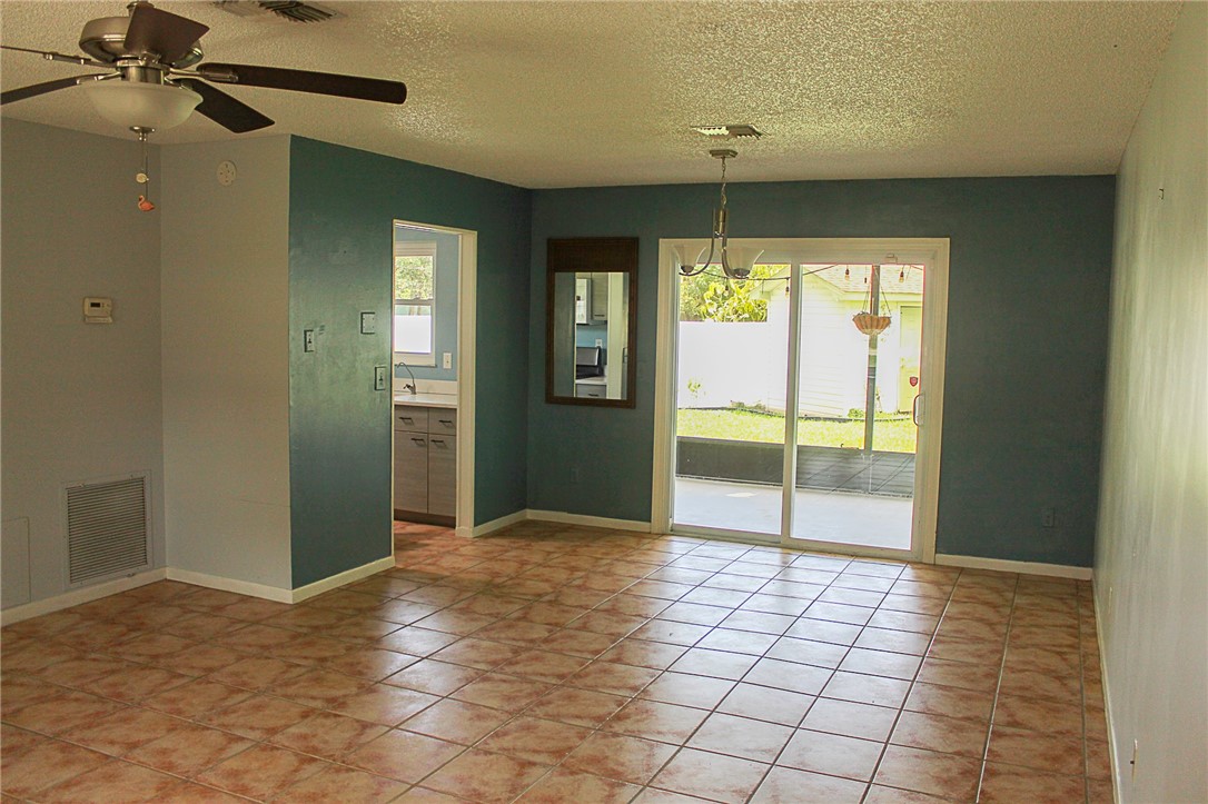 102 Cardinal Drive Sebastian, FL 32958 - Photo 14 of 34 a view of a room with a chandelier fan and windows
