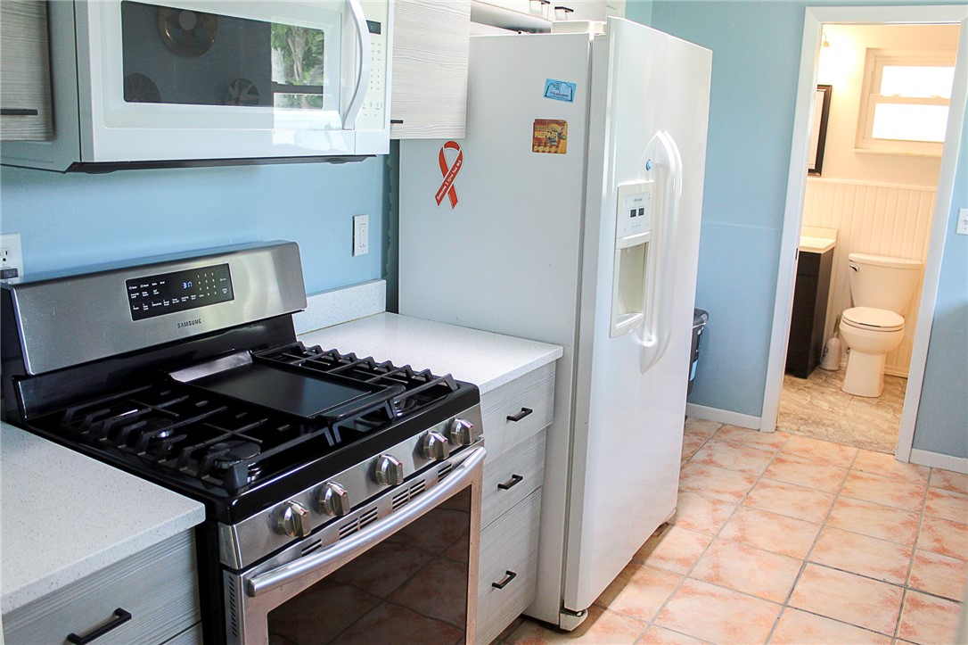 102 Cardinal Drive Sebastian, FL 32958 - Photo 19 of 34 a kitchen with a stove and a refrigerator