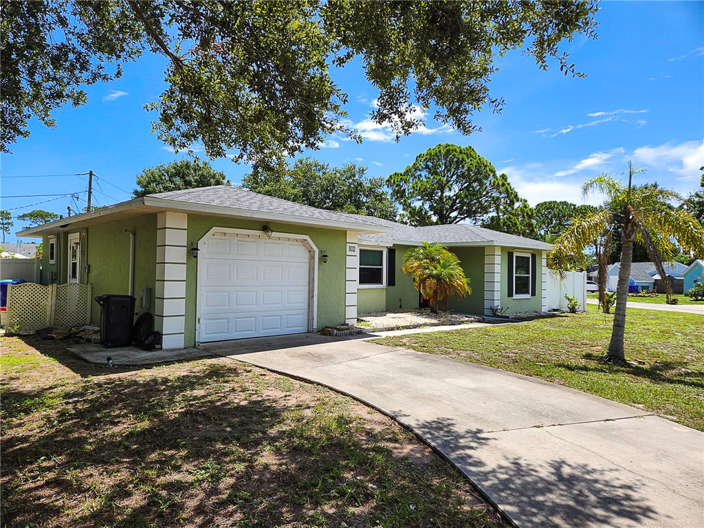 102 Cardinal Drive Sebastian, FL 32958 - Photo 2 of 34 a front view of a house with a garden