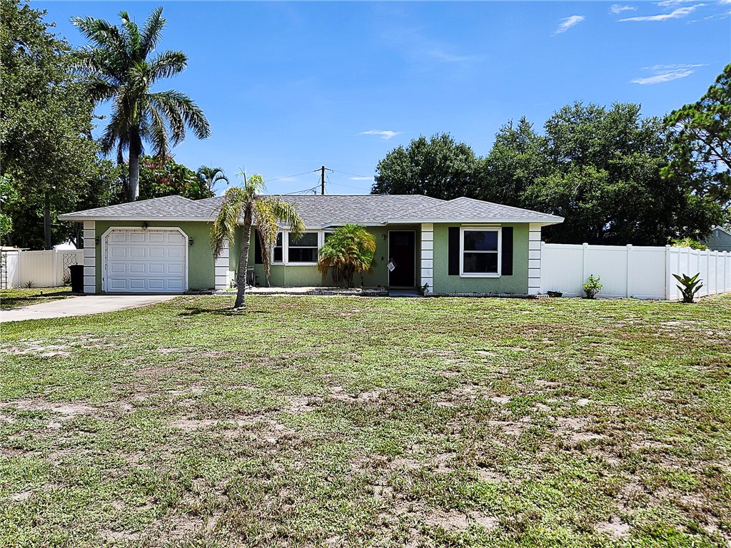 102 Cardinal Drive Sebastian, FL 32958 - Photo 3 of 34 a front view of the house with a garden