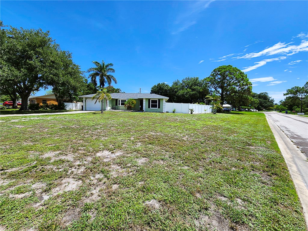 102 Cardinal Drive Sebastian, FL 32958 - Photo 5 of 34 a view of a large garden with large trees
