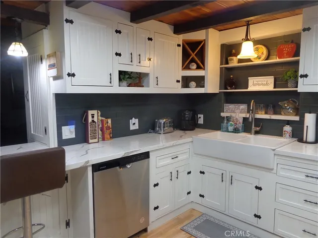 a kitchen with stainless steel appliances white cabinets and a refrigerator