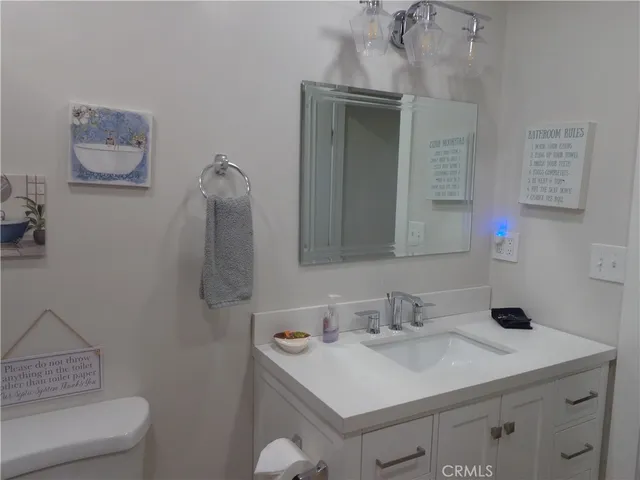 a bathroom with a sink toilet and mirror