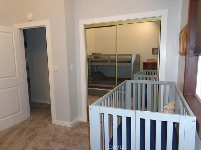 a view of staircase with wooden floor and a flat screen tv