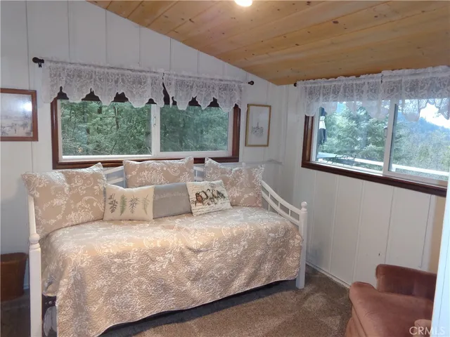 a bedroom with bed and a large window