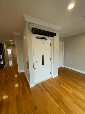 an empty room with wooden floor and closet