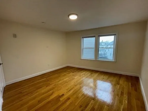 a view of an empty room and wooden floor