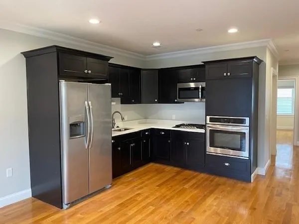 a view of kitchen with wooden floor