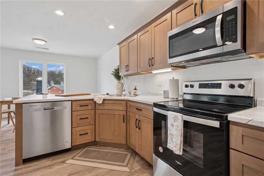 1632 Lois Road, Unit LOT 22 A Latrobe, PA 15650 - Photo 13 of 31 a kitchen with stainless steel appliances granite countertop a stove microwave and cabinets