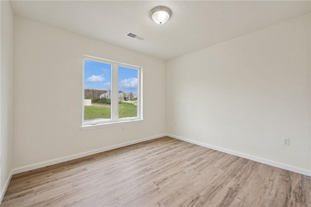 1632 Lois Road, Unit LOT 22 A Latrobe, PA 15650 - Photo 17 of 31 an empty room with wooden floor and windows