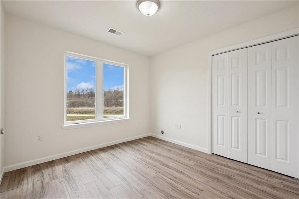 1632 Lois Road, Unit LOT 22 A Latrobe, PA 15650 - Photo 20 of 31 a view of an empty room with wooden floor and a window